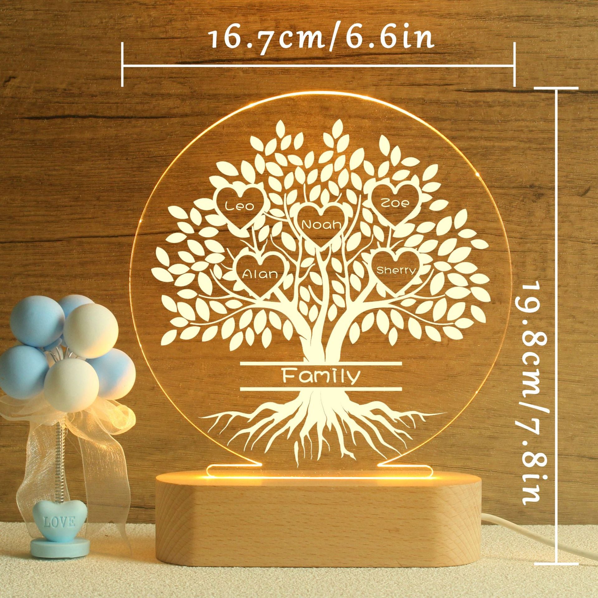 Close-up of custom family names engraved on acrylic tree design