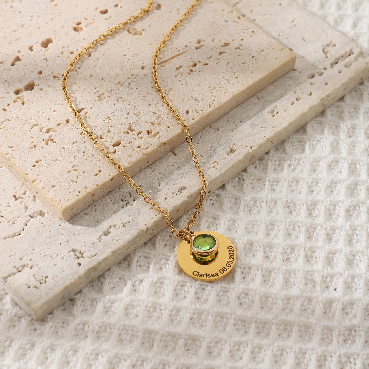 Close-up of engraved name pendant featuring sparkling crystal accent