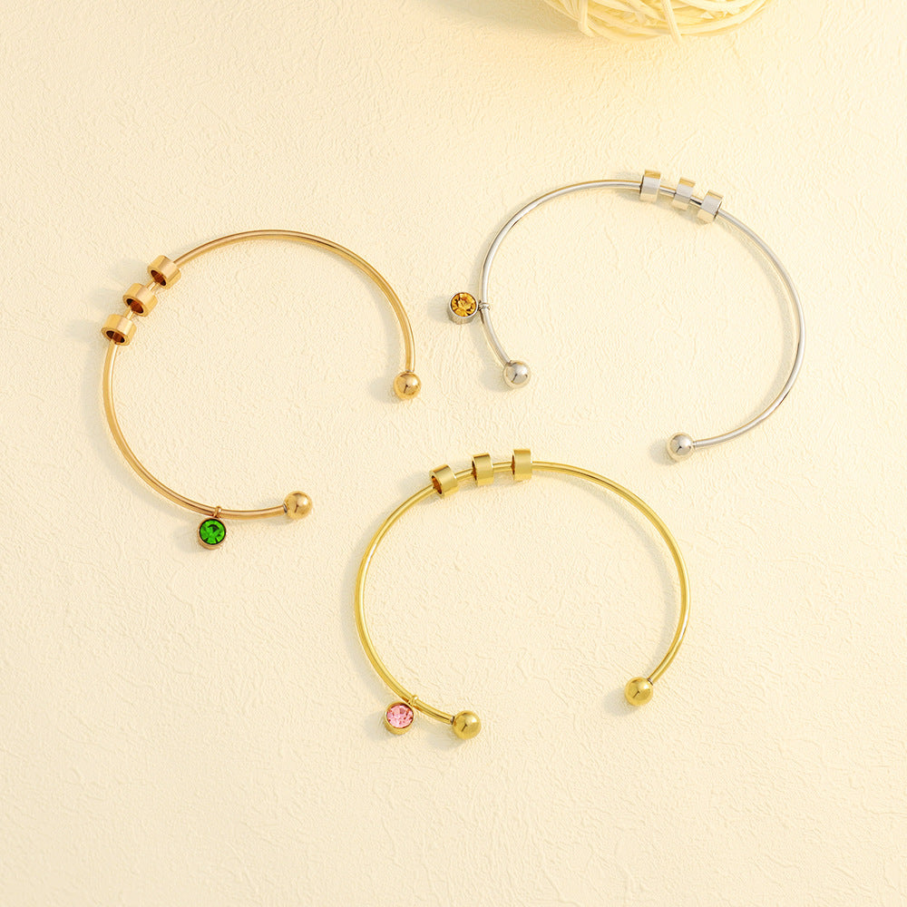 Personalised birthstone bangle with engraved name bead in gold and silver