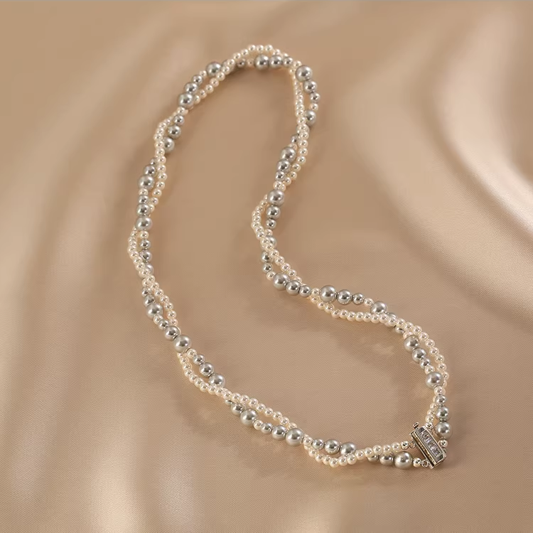 Handmade double-layer pearl choker necklace crafted in S925 sterling silver on soft neutral background