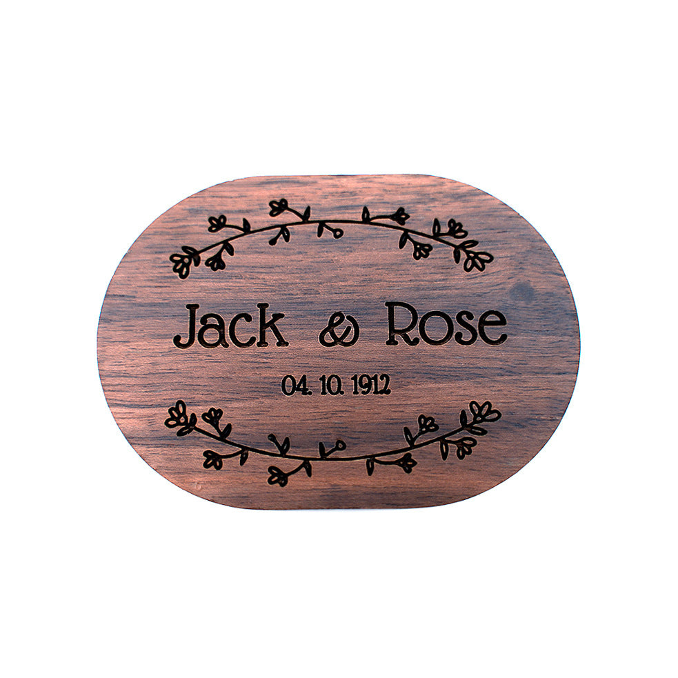 Oval walnut ring box with custom engraved names and floral design