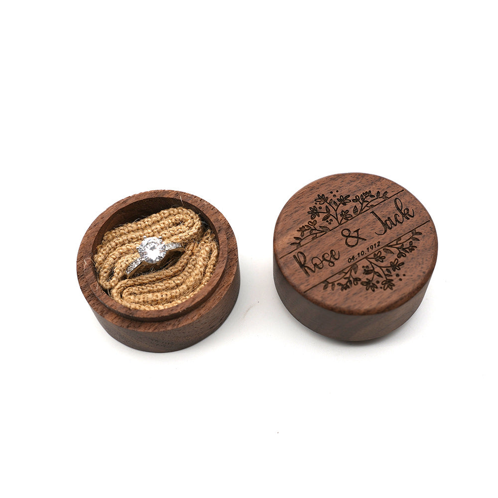 Round walnut ring box with custom engraved names and floral design