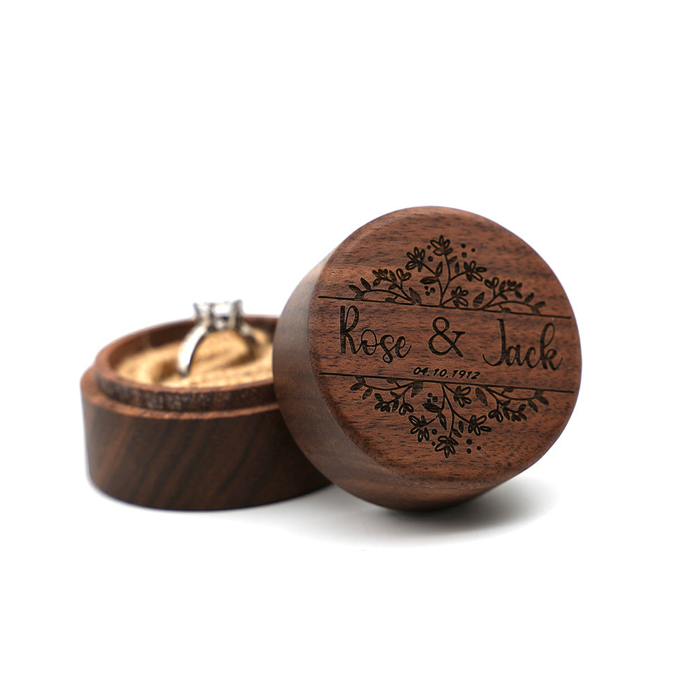 Round walnut ring box with custom engraved names and floral design