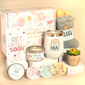 A Box of Hugs get well soon gift box with tumbler, fuzzy socks, greeting card, candle, succulent and shower steamers.