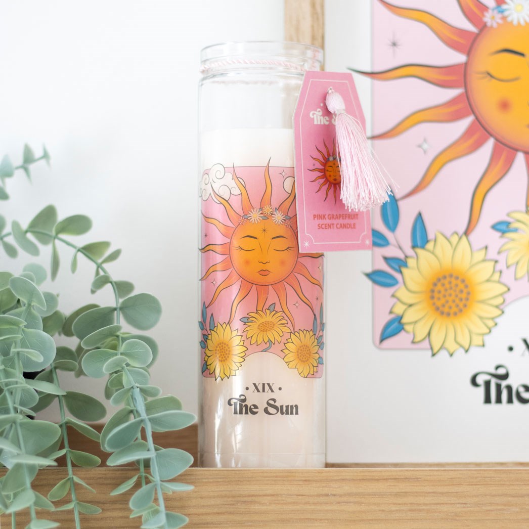 The Sun Pink Grapefruit Tube Candle with tarot-inspired sun design and pink tassel – bright citrus fragrance and long burn time.