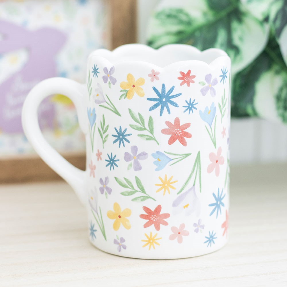 White ceramic scalloped mug with pastel floral print — perfect spring gift for Mum or floral lovers.