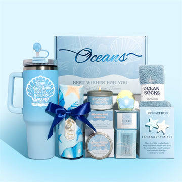 Ocean themed pamper gift box with shell tumbler, towel, fuzzy socks, candle, ocean soap, shell bath bomb and pocket hug card.