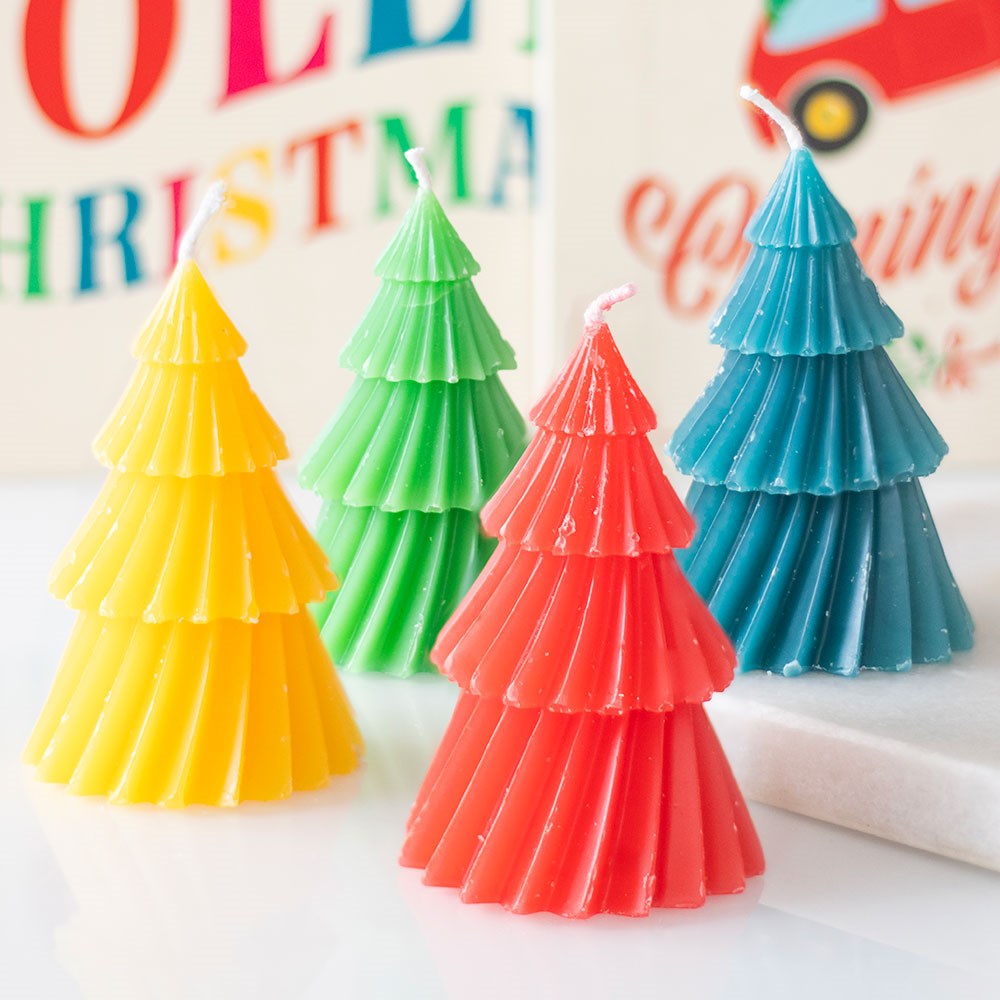 Set of four colourful Christmas tree candles in red, green, yellow, and blue – festive home décor for Christmas celebrations.