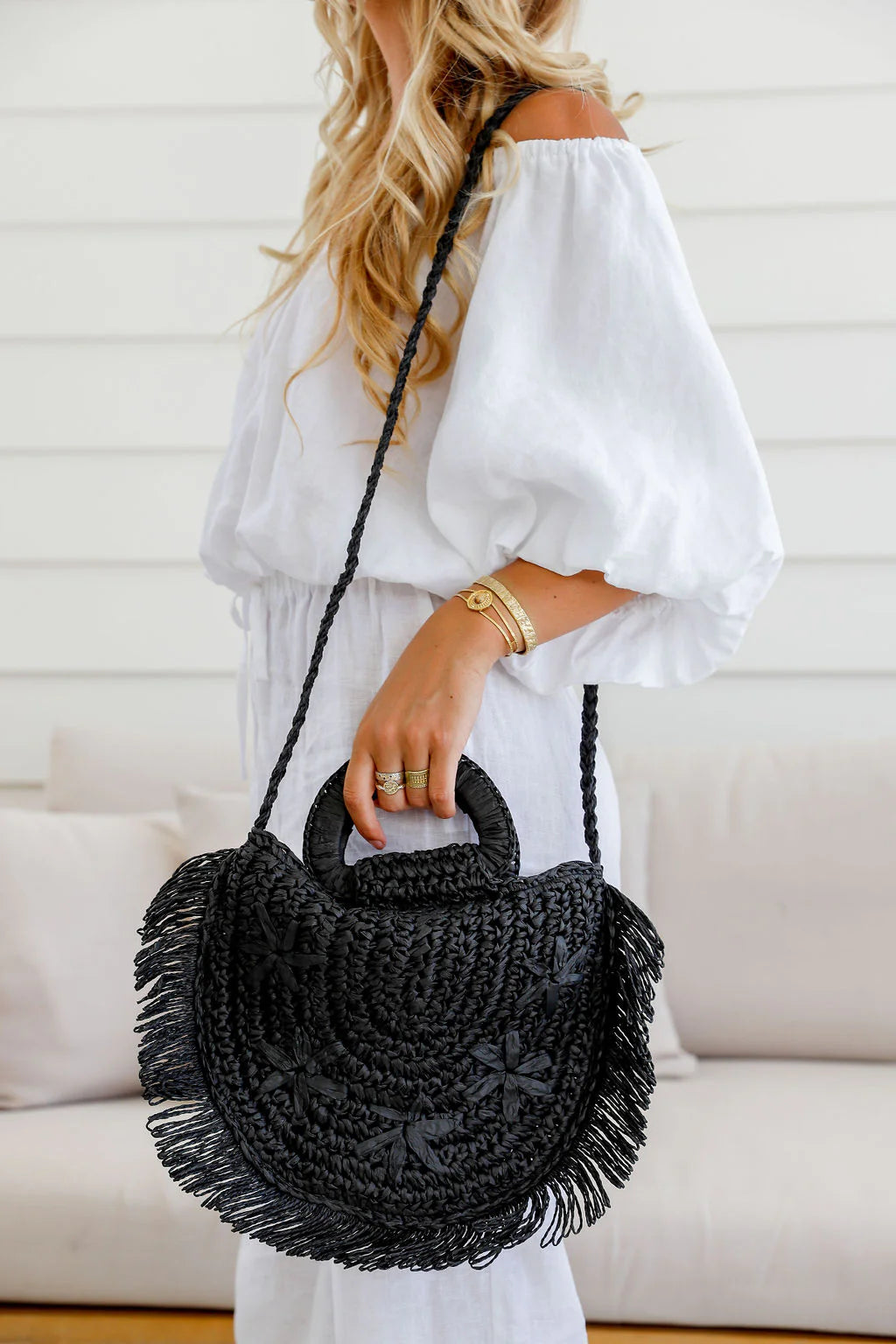 Woman holding black woven fringe tote bag – stylish women’s woven tote and perfect gift for her
