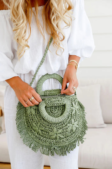 Woman holding khaki woven straw tote bag – handwoven women’s bag and gift for her