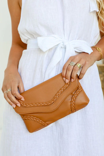 Woman wearing a tan braid detail shoulder bag made from vegan leather – women’s bag and gift for her