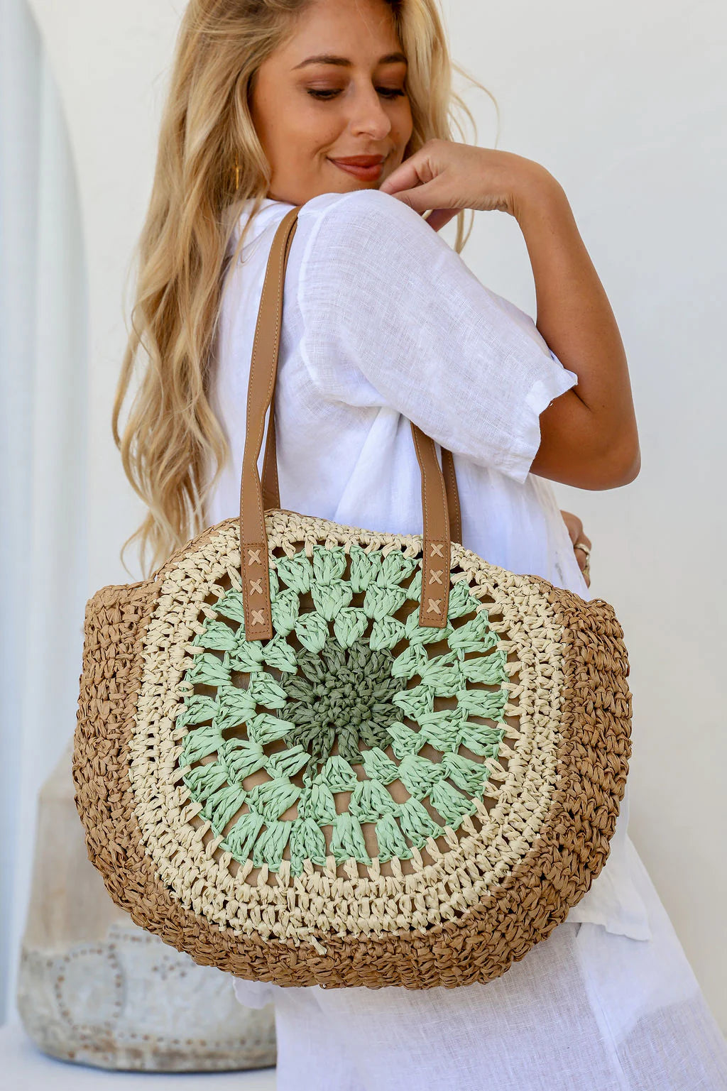 Woman carrying a mint and tan circle weave tote bag – handcrafted women’s tote and perfect gift for her