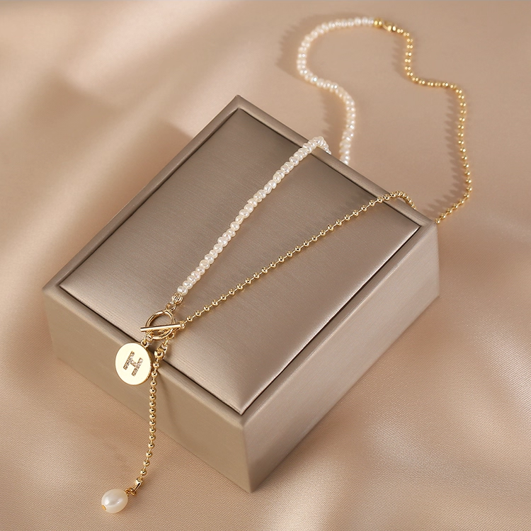 Handmade pearl initial necklace featuring micro pearls and an S925 sterling silver chain with personalised letter charm