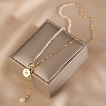Handmade pearl initial necklace featuring micro pearls and an S925 sterling silver chain with personalised letter charm