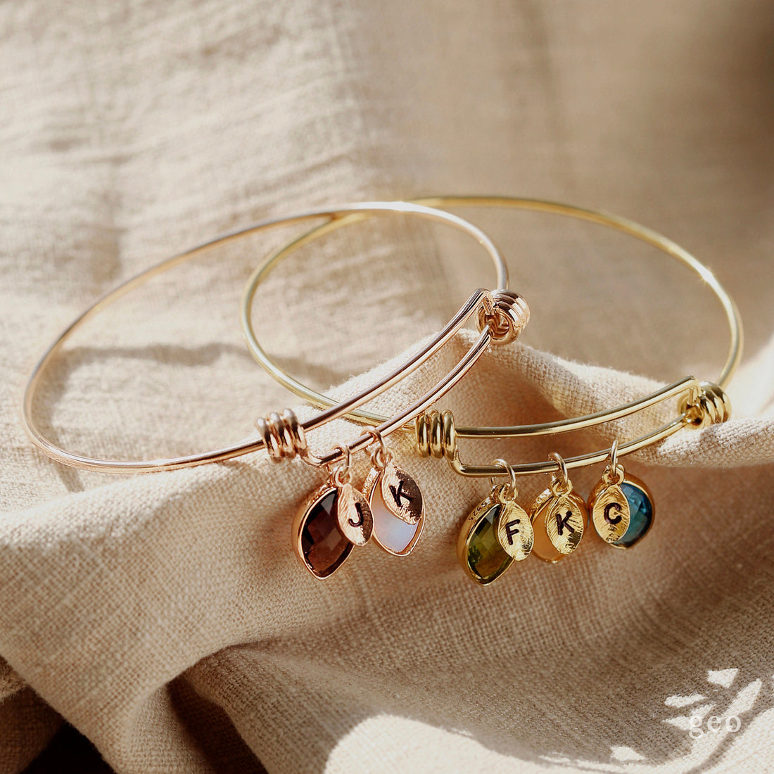 Adjustable personalised bangle with engraved disc and birthstone charms in gold and silver
