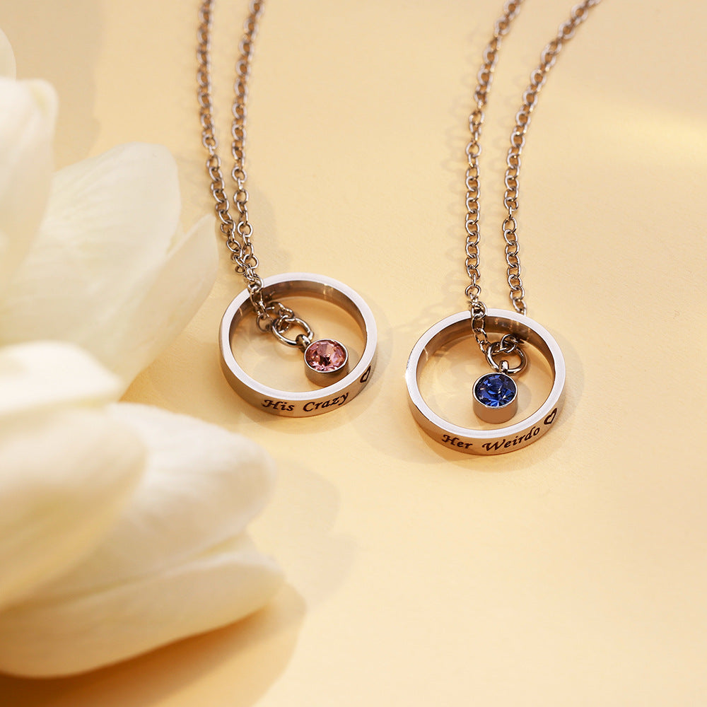 Stainless steel circle necklace with personalised engraving and blue birthstone
