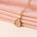 Gold heart locket necklace with engraved name inside