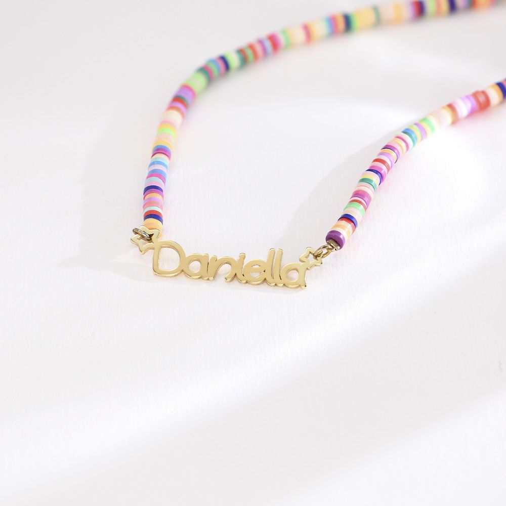 Close-up of colourful clay beads with custom name on gold chain