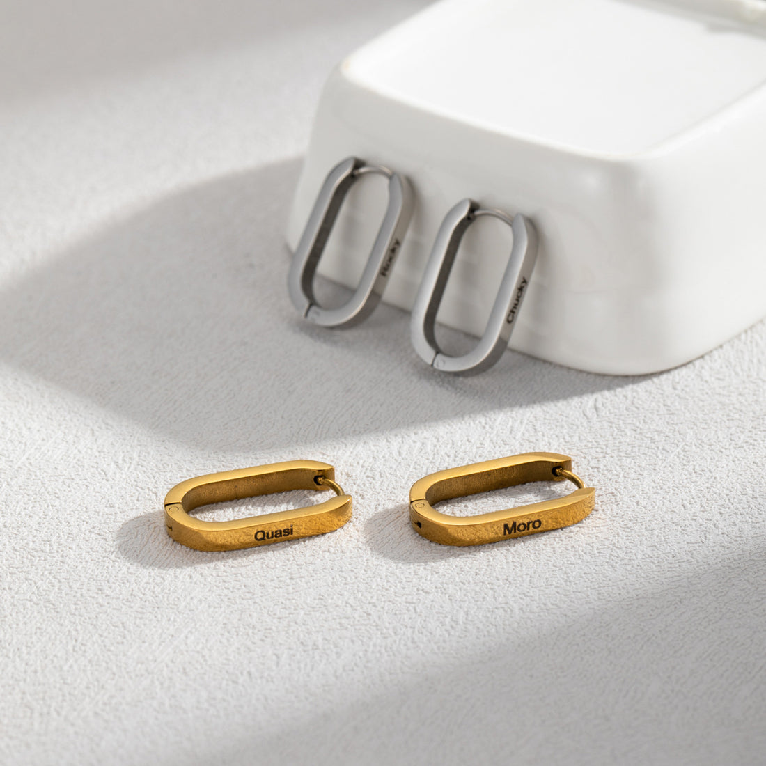 Personalised stainless steel U-shaped hoop earrings in silver, gold, and rose gold with custom engraved names – elegant minimalist jewellery gift for her.