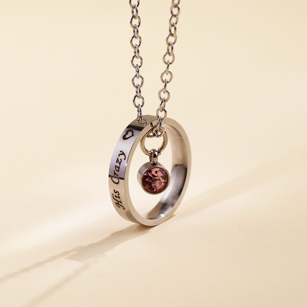 Stainless steel circle necklace with personalised engraving and blue birthstone