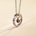 Stainless steel circle necklace with personalised engraving and blue birthstone