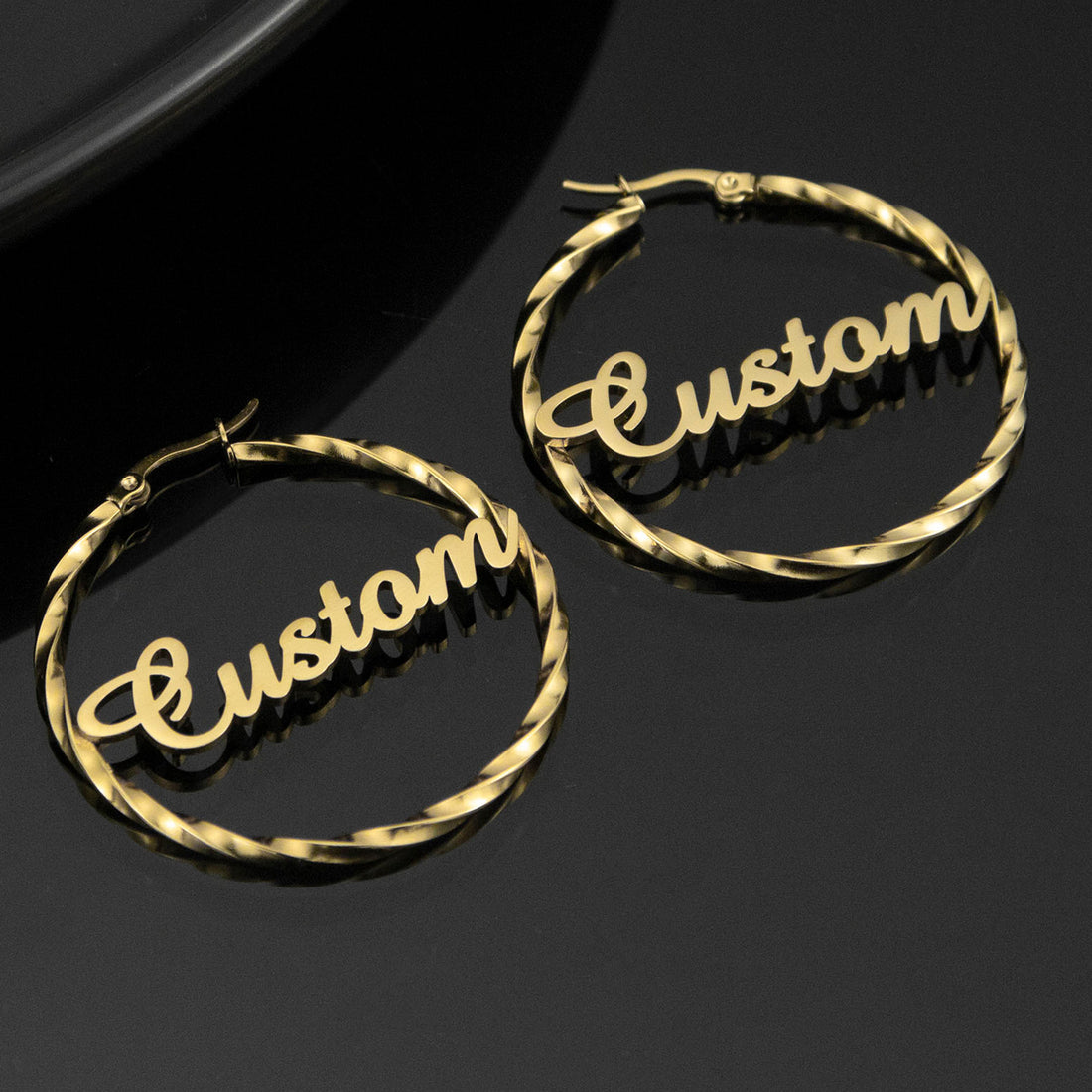 Personalised gold twisted hoop earrings with custom name in script font — stylish stainless steel circle earrings gift for her.