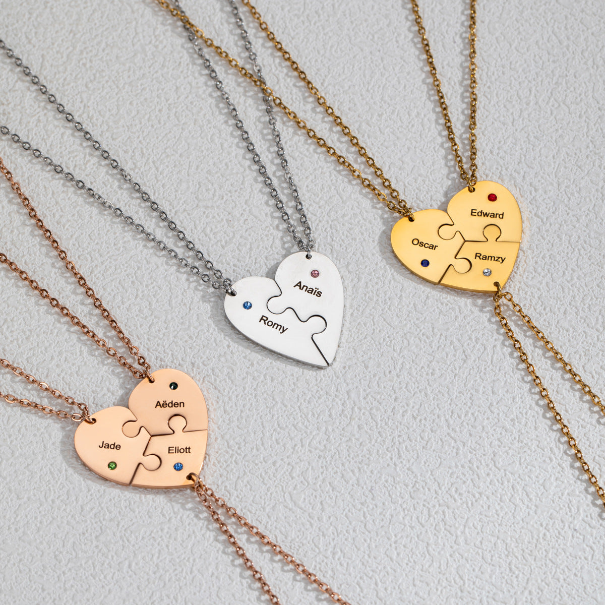 Close-up of engraved names and birthstones on interlocking heart pendant