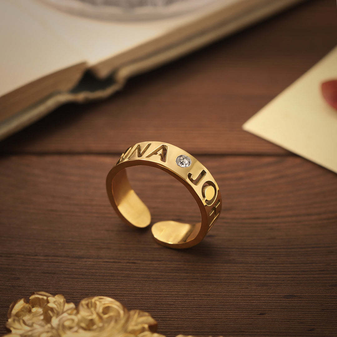 Personalised birthstone name ring in gold with engraved letters and adjustable open band – custom gift for her.
