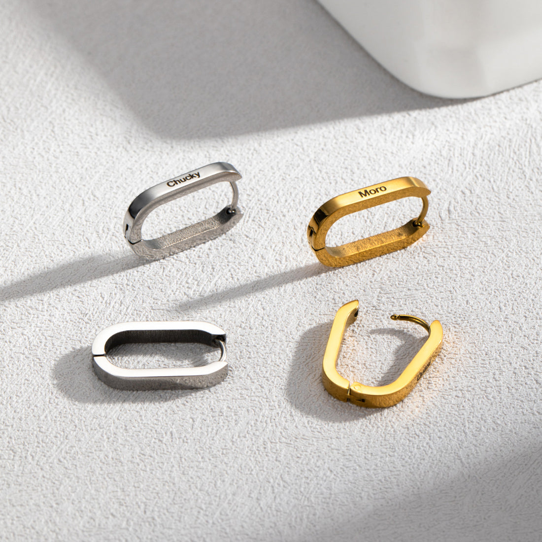 Personalised stainless steel U-shaped hoop earrings in silver, gold, and rose gold with custom engraved names – elegant minimalist jewellery gift for her.