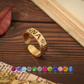Personalised birthstone name ring in gold with engraved letters and adjustable open band – custom gift for her.