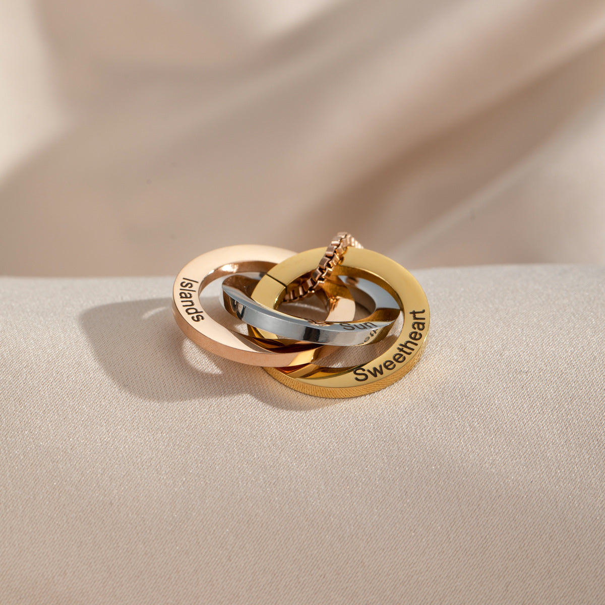 Close-up of interlocking rings with custom name engraving